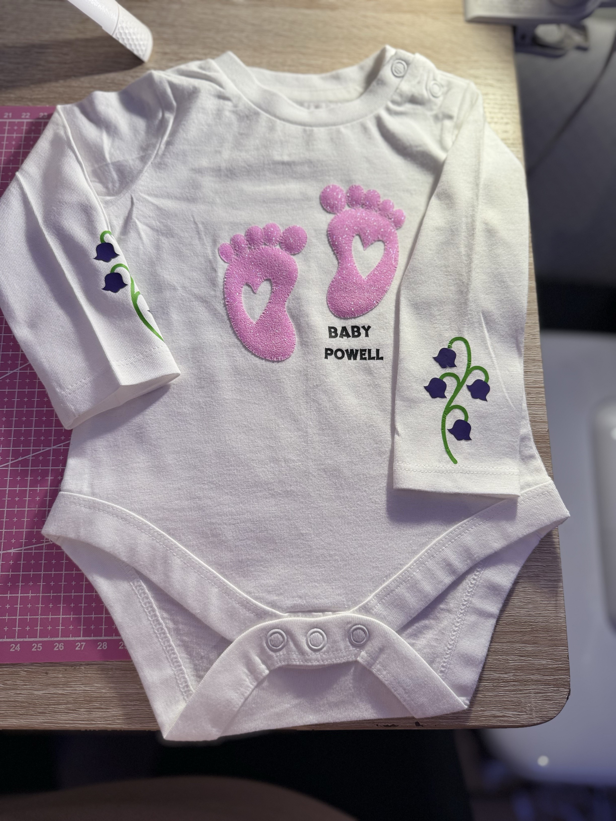 Babygrow with glitter puff feet - personalised with their surname